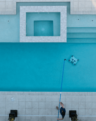 Water Tech robotic pool cleaner sweeping the bottom of a pool